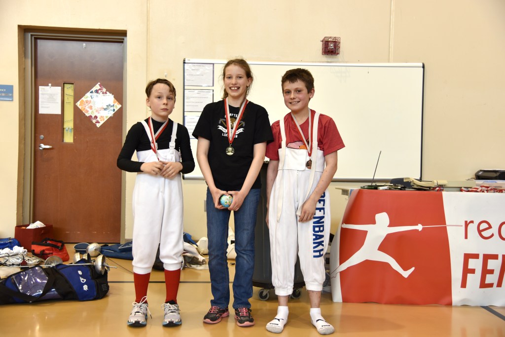 Y12 medalists: (from left) 2nd - Victor, 1st - Posy, 3rd - Danny, all from RDF. This was their first tournament!